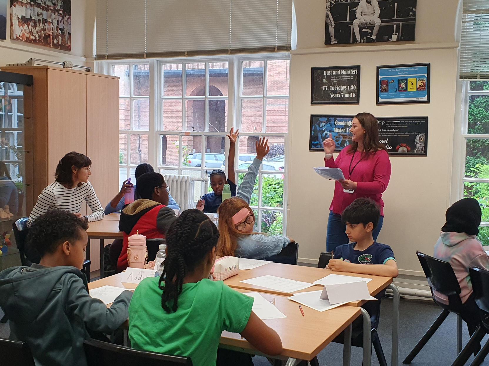A teacher leading a classroom discussion with pupils